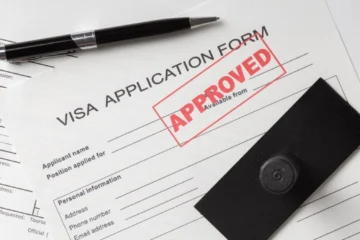 flat-lay-visa-application-assortment: Immigration Scam Se Bache