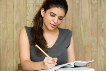 Exam Preparation | portrait-smiling-student-writing-classroom