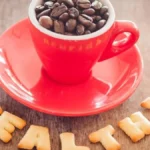 Coffee Health Benefits | close-up-coffee-beans-cup-with-snacks-table